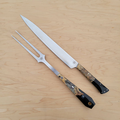 Two knives with decorative handles on a wooden surface