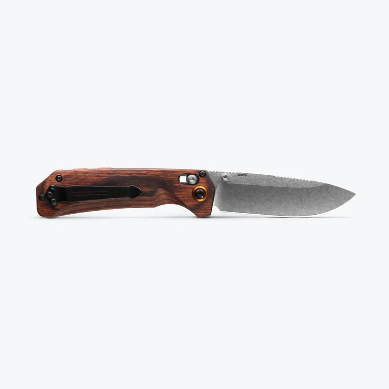 Folding knife with wooden handle on a white background