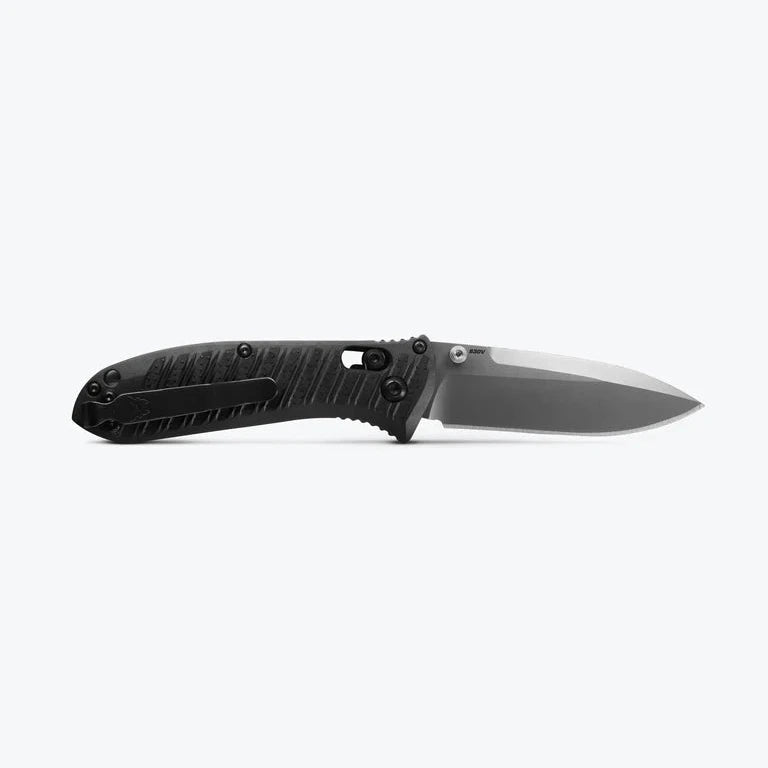 Folding knife with a black handle and silver blade on a white background