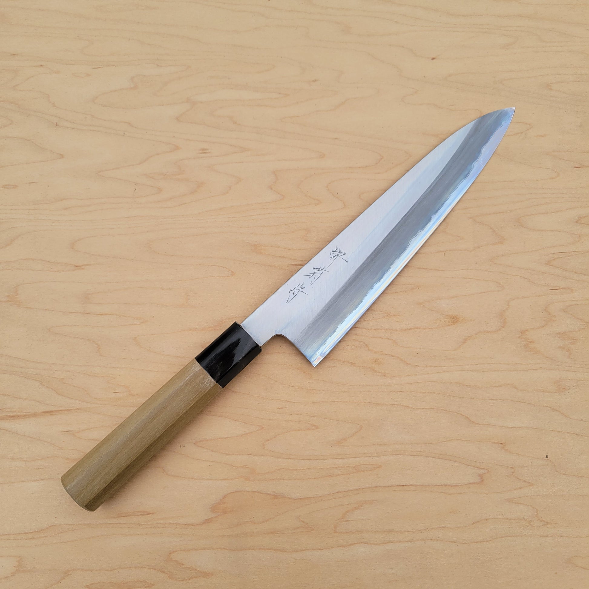 Knife with a wooden handle on a light wood background