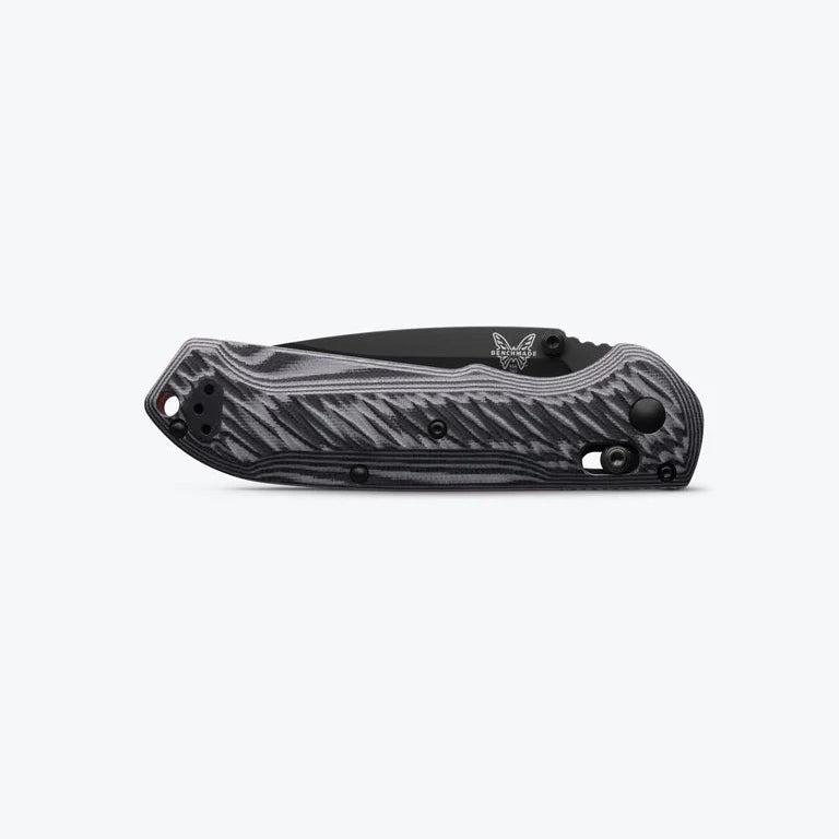 Black folding knife with a textured handle on a white background