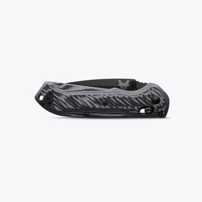 Black folding knife with a textured handle on a white background