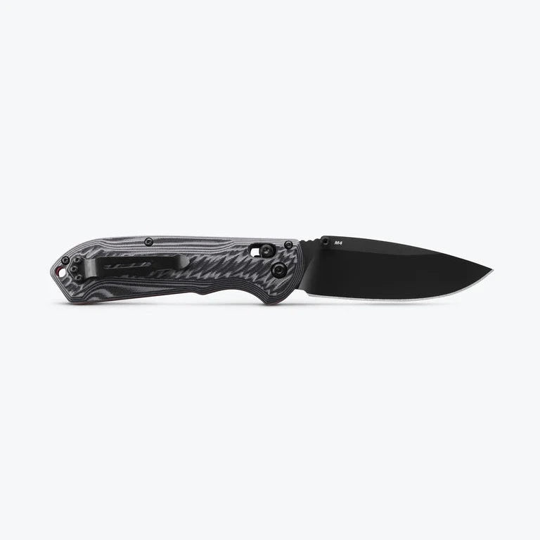 Black folding knife with a textured handle on a white background