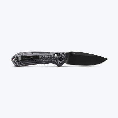 Black folding knife with a textured handle on a white background