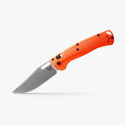 Orange folding knife with a silver blade on a white background