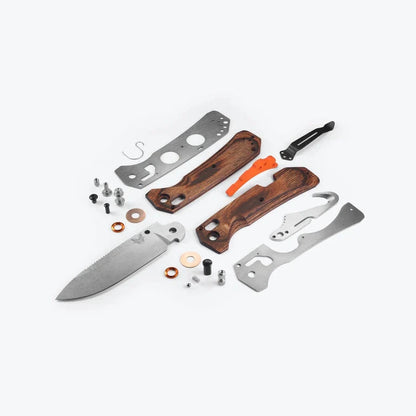 Knife components including blade, handle, and metal parts on a white background