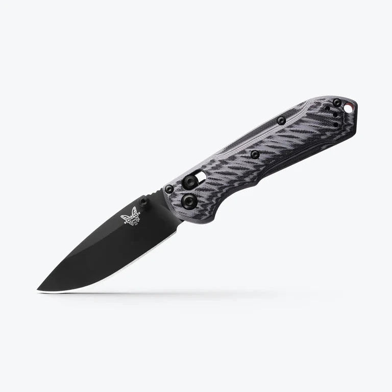 Folding knife with black blade and gray handle on a white background